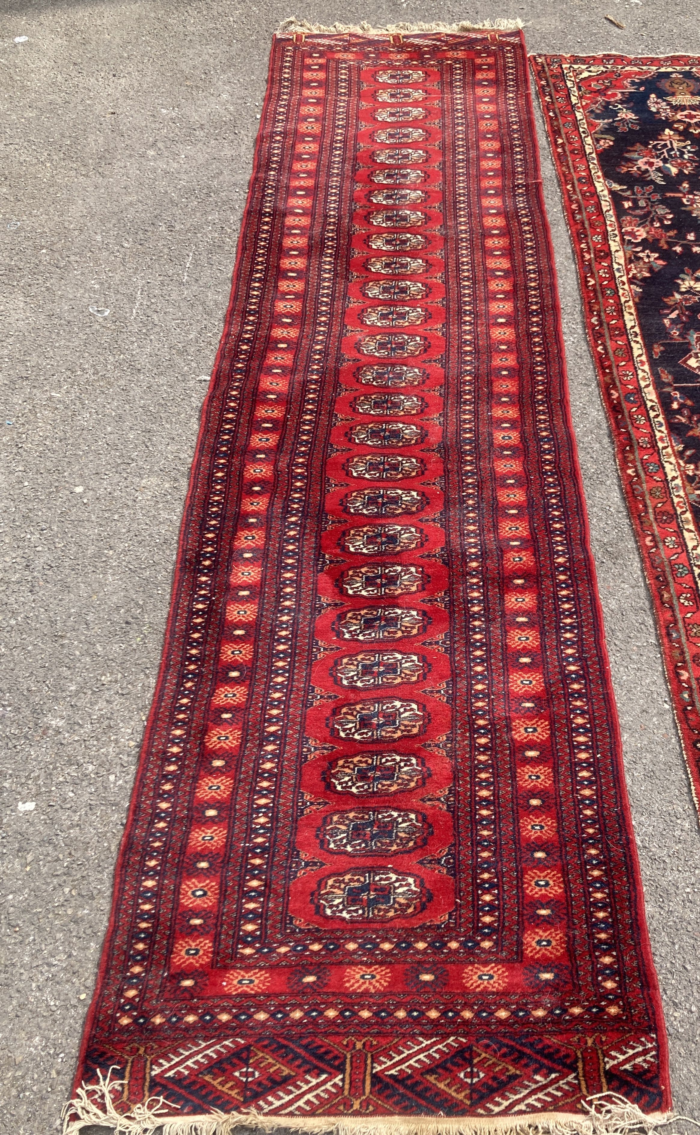 A Bokhara red ground runner, 305 x 80cm, together with a smaller Kashan style rug